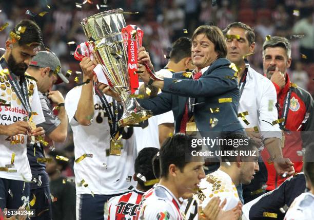 Mexico's Guadalajara coach, Argentinian Matias Almayda and players celebrate with the trophy following victory over Canada's Toronto FC in their...