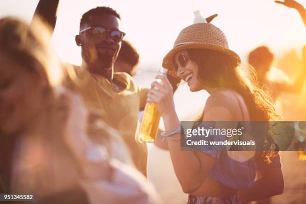 young multi-ethnic hipster friends dancing at summer beach party - drink stock pictures, royalty-free photos & images