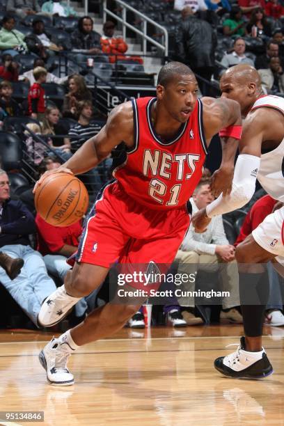 Bobby Simmons of the New Jersey Nets drivse to the basket against Maurice Evans of the Atlanta Hawks during the game at Philips Arena on December 13,...