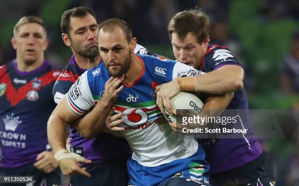 Simon Mannering of the Warriors is tackled by Tim Glasby of the Melbourne Storm and Cameron Smith of the Melbourne Storm during the round eight NRL...
