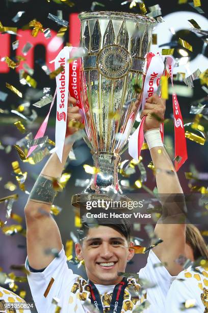 Alan Pulido of Chivas celebrates with the champions trophy after the second leg match of the final between Chivas and Toronto FC as part of CONCACAF...