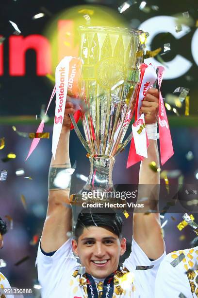 Alan Pulido of Chivas celebrates with the champions trophy after the second leg match of the final between Chivas and Toronto FC as part of CONCACAF...