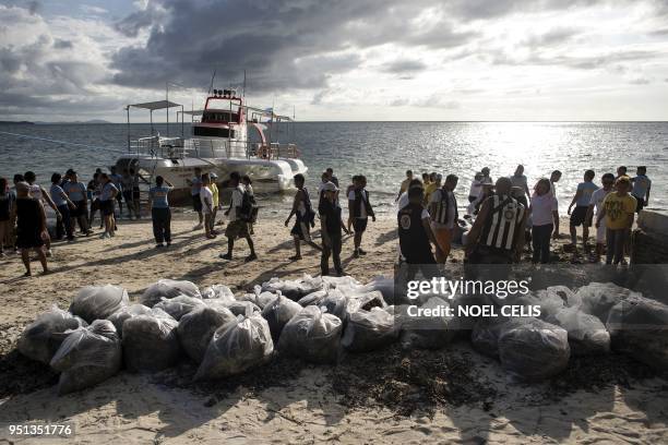 Volunteers and government employees participate in a coastal clean-up on Bulabog beach on the Philippine island of Boracay on April 26, 2018. - The...