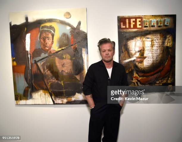 John Mellencamp stands in front of his work during private viewing of "Life, Death, Love, Freedom" at ACA Galleries on April 25, 2018 in New York...