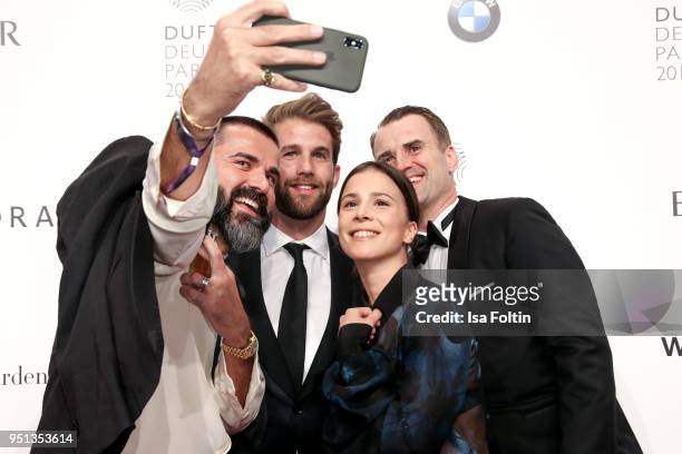 Andreas Haumesser, model Andre Hamann, German actress Aylin Tezel and Jens Ciliax during the Duftstars at Flughafen Tempelhof on April 25, 2018 in...