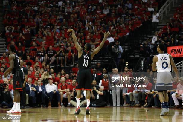 James Harden of the Houston Rockets reacts after shooting a three point shot in the second half defended by Jeff Teague of the Minnesota Timberwolves...