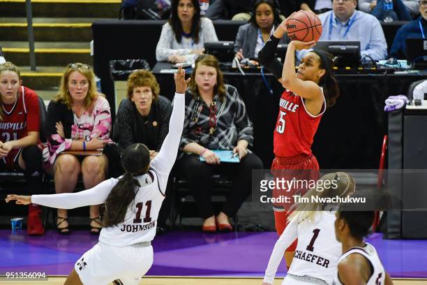 Asia Durr of the Louisville Cardinals attempts a three point basket over Roshunda Johnson of the Mississippi State Bulldogs during a semifinal game...