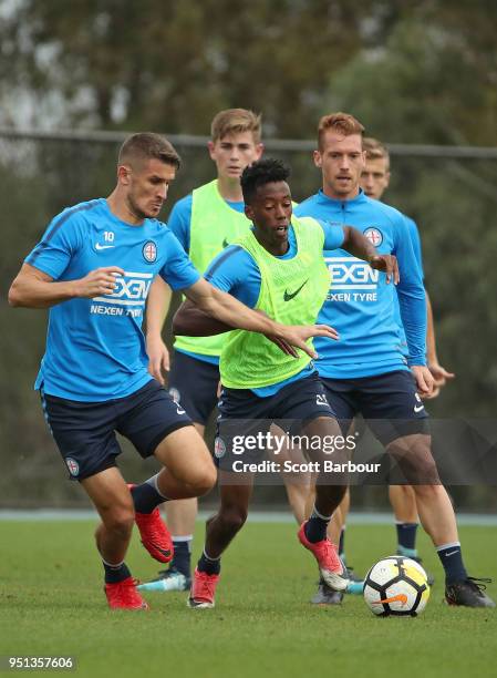 Dario Vidosic and Bruce Kamau of City FC compete for the ball during a Melbourne City FC A-League training session at City Football Academy on April...