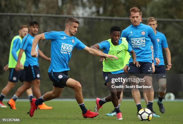Dario Vidosic and Bruce Kamau of City FC compete for the ball during a Melbourne City FC A-League training session at City Football Academy on April...