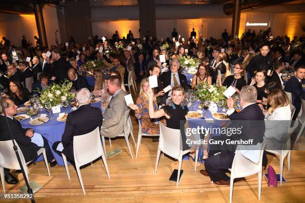 Guests participate in art auction at the Housing Works' Groundbreaker Awards at Metropolitan Pavilion on April 25, 2018 in New York City.