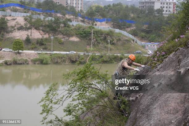 Shop hanging midair on a cliff face opens for rock climbers who need to replenish nutrients consumed by physical strength at Shiniu Village on April...