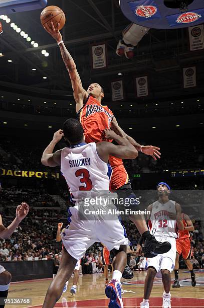 Monta Ellis of the Golden State Warriors shoots a layup against Rodney Stuckey of the Detroit Pistons during the game at the Palace of Auburn Hills...