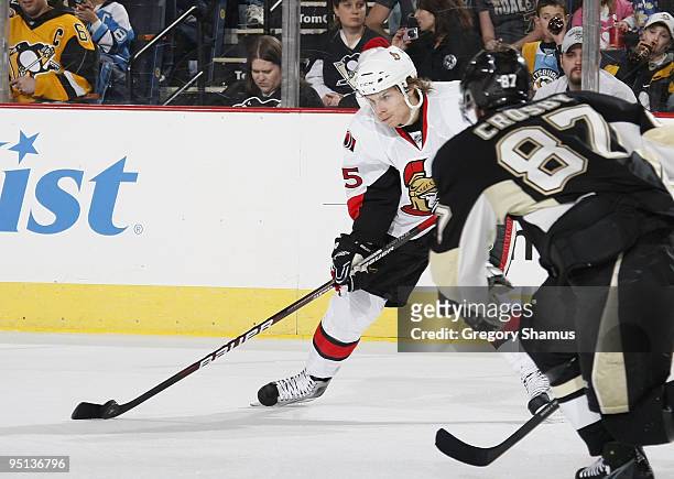 Erik Karlsson of the Ottawa Senators controls the puck in front of Sidney Crosby of the Pittsburgh Penguins on December 23, 2009 at Mellon Arena in...