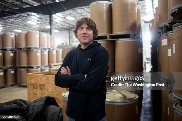 Farm Manager Nickolas Sandquist stands in front of roughly 80,000 pounds worth of ginseng that is ready to be shipped to China, as seen at Hsu...