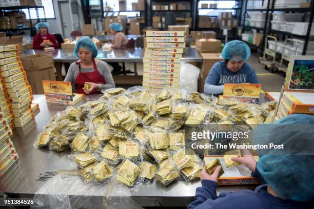 Employees prepare packages of tea at Hsu's Ginseng Enterprise in Wausau, Wisconsin Monday, April 9, 2018.