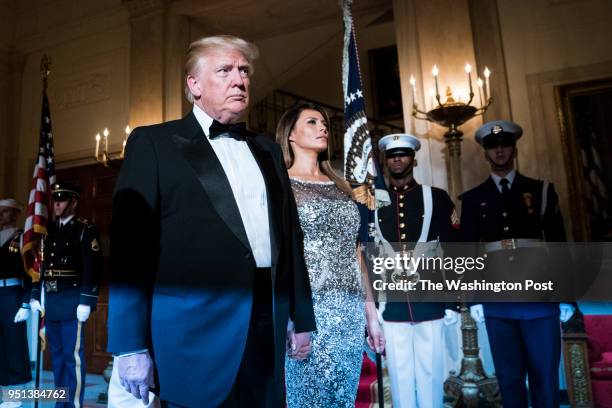 President Donald J. Trump and first lady Melania Trump walk out with French President Emmanuel Macron and his wife Brigitte Macron in the Grand Foyer...