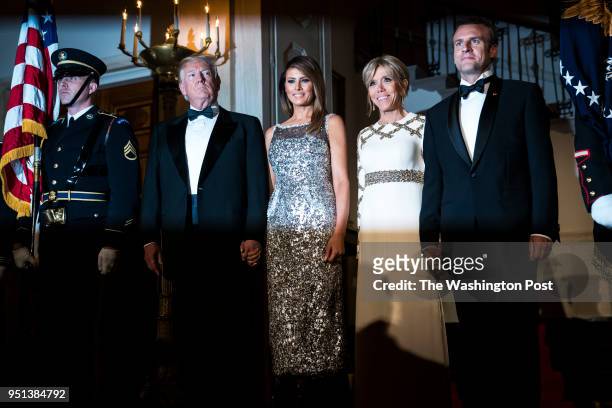 President Donald J. Trump and first lady Melania Trump walk out with French President Emmanuel Macron and his wife Brigitte Macron in the Grand Foyer...