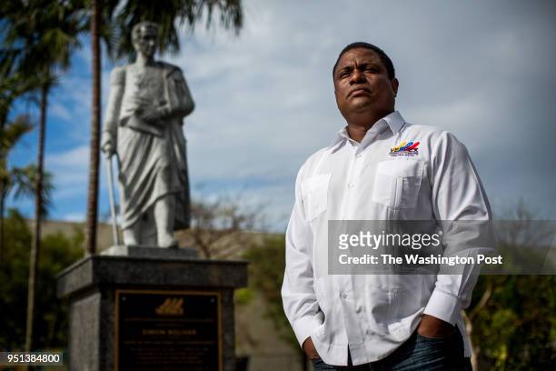 Jose Antonio Colina, leader of the Venezuelan exile group, Veppex, alongside a statue of Simon Bolivar outside of El Arepazo in Doral, FL on Monday,...