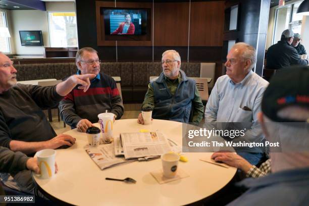 Dennis Schminke, center right, 38 years a Hormel employee and Republican party activist, has his morning political coffee klatch with friends, Dan...