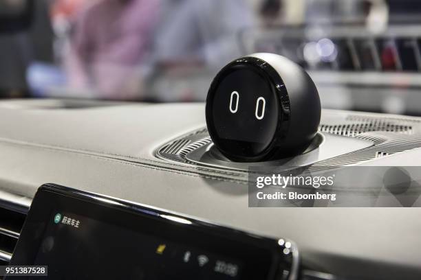 The in-car artificial intelligence system, sits above the dashboard of a NIO ES8 electric sports utility vehicle on display at the Beijing...