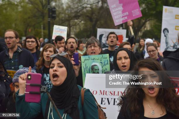 Demonstrators against Donald Trump's Muslim travel ban gather outside the United States Supreme Court as the court hears a case involving the travel...