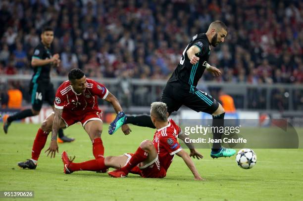 Karim Benzema of Real Madrid between Thiago Alcantara and Rafinha of Bayern Munich during the UEFA Champions League Semi Final first leg match...