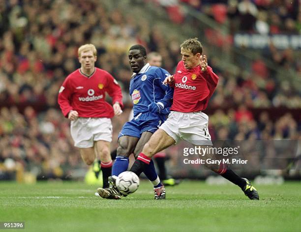 Ade Akinbiyi of Leicester City holds the ball up against Phil Neville of Manchester United during the FA Carling Premiership match played at Old...