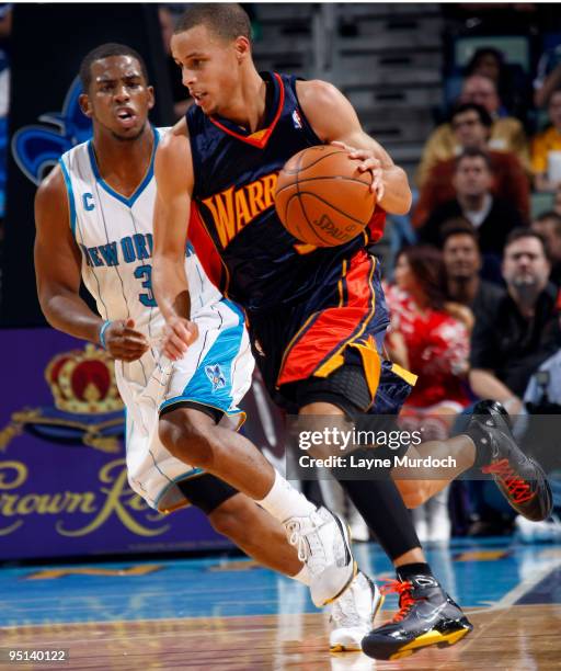 Stephen Curry of the Golden State Warriors drives past Chris Paul of the New Orleans Hornets on December 23, 2009 at the New Orleans Arena in New...