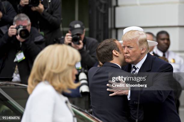 President Donald Trump, right, greets Emmanuel Macron, France's president, at an arrival ceremony during a state visit on the South Lawn of the White...