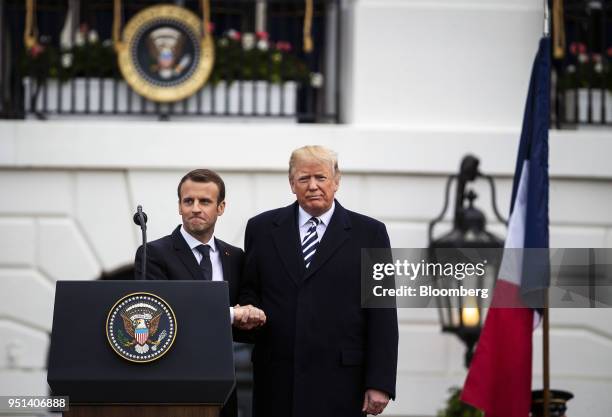 Emmanuel Macron, France's president, left, shakes hands with U.S. President Donald Trump, at an arrival ceremony during a state visit in Washington,...