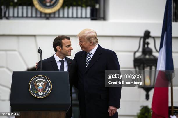 Emmanuel Macron, France's president, left, greets U.S. President Donald Trump, at an arrival ceremony during a state visit in Washington, D.C., U.S.,...