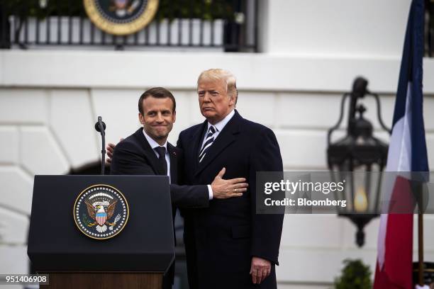 Emmanuel Macron, France's president, left, greets U.S. President Donald Trump, at an arrival ceremony during a state visit in Washington, D.C., U.S.,...