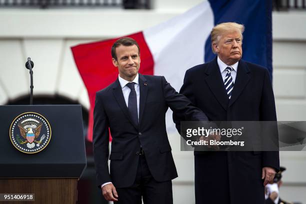 Emmanuel Macron, France's president, left, shakes hands with U.S. President Donald Trump at an arrival ceremony during a state visit in Washington,...