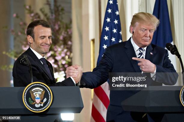 President Donald Trump, right, points to Emmanuel Macron, France's president, at a news conference during a state visit in the East Room of the White...