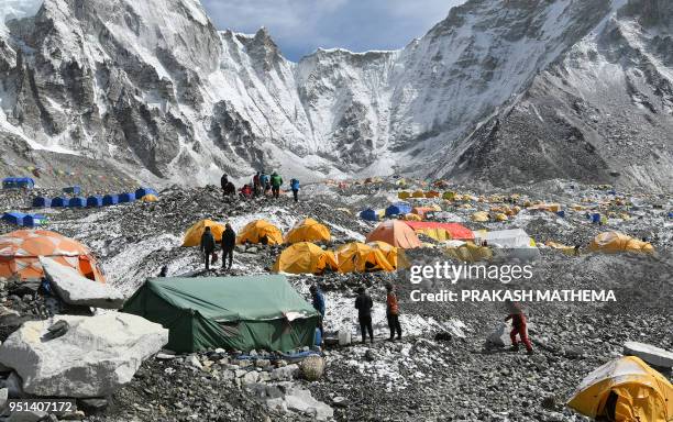 In this photograph taken on April 25 trekkers and porters gather at Everest Base Camp, some 140km northeast of the Nepali capital Kathmandu. -...