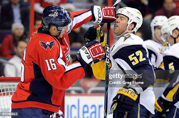 Eric Fehr of the Washington Capitals pushes Craig Rivet of the Buffalo Sabres at the Verizon Center on December 23, 2009 in Washington, DC.