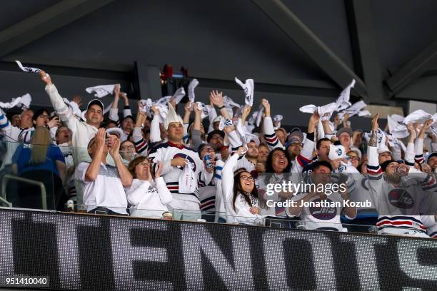 Winnipeg Jets fans clad all in white wave towels as they cheer the team on during first period action against the Minnesota Wild in Game Five of the...