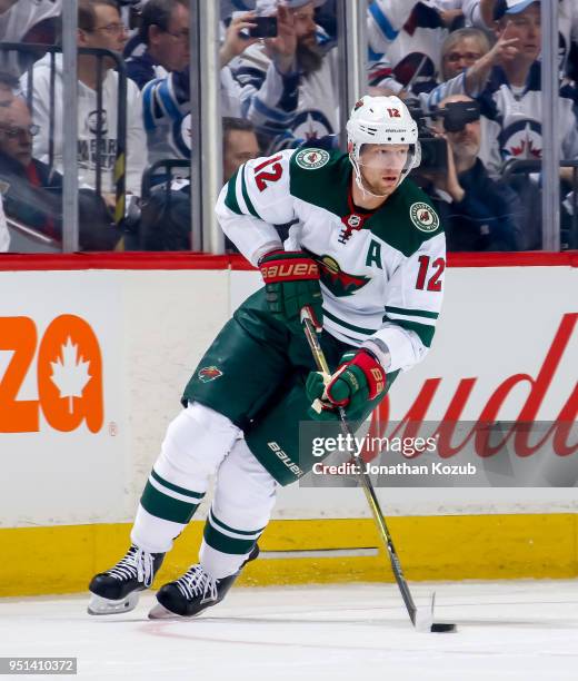 Eric Staal of the Minnesota Wild plays the puck down the ice during first period action against the Winnipeg Jets in Game Five of the Western...