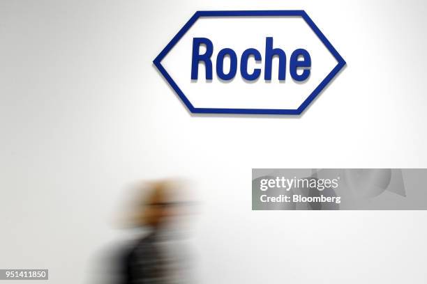 Company logo hangs on the wall at the Roche Holding AG headquarters in Basel, Switzerland, on Thursday, April 26, 2018. The worlds biggest maker of...