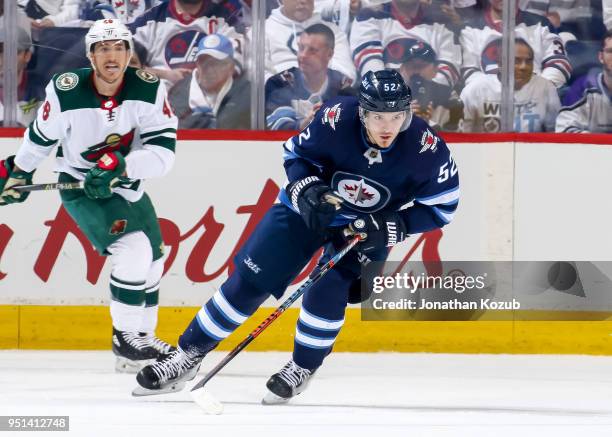 Jack Roslovic of the Winnipeg Jets follows the play down the ice during first period action against the Minnesota Wild in Game Five of the Western...