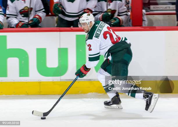 Nino Niederreiter of the Minnesota Wild plays the puck down the ice during second period action against the Winnipeg Jets in Game Five of the Western...