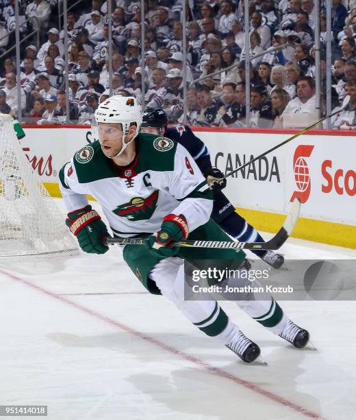 Mikko Koivu of the Minnesota Wild follows the play around the boards during third period action against the Winnipeg Jets in Game Five of the Western...