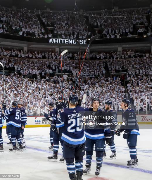 Winnipeg Jets players salute the fans following a 5-0 victory over the Minnesota Wild in Game Five of the Western Conference First Round during the...