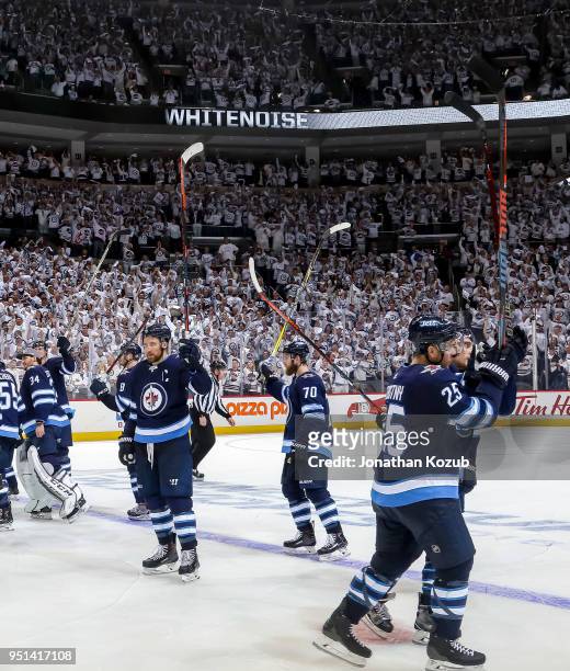 Winnipeg Jets players salute the fans following a 5-0 victory over the Minnesota Wild in Game Five of the Western Conference First Round during the...