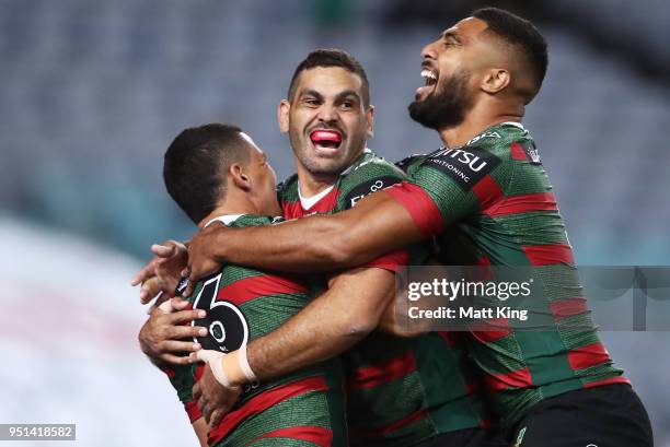 Cody Walker of the Rabbitohs celebrates with Greg Inglis and Robert Jennings after scoring the first try in the NRL round eight match between the...