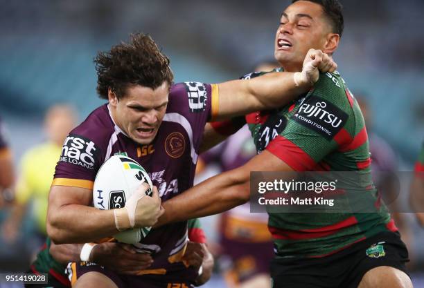 James Roberts of the Broncos is tackled by John Sutton of the Rabbitohs in the NRL round eight match between the South Sydney Rabbitohs and the...