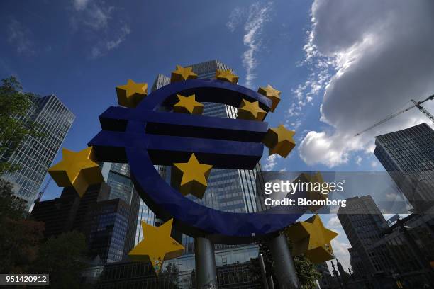 The euro sign sculpture stands near the former European Central Bank headquarters in Frankfurt, Germany, on Wednesday, April 25, 2018. About 8,000...