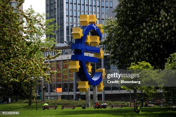 The euro sign sculpture stands near the former European Central Bank headquarters in Frankfurt, Germany, on Wednesday, April 25, 2018. About 8,000...