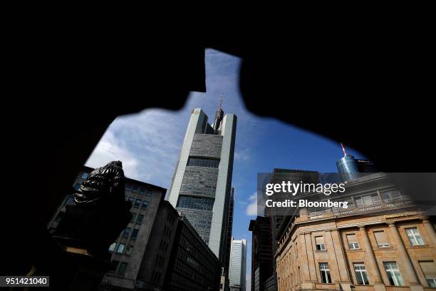 The Commerzbank AG bank headquarters stands above other buildings in Frankfurt, Germany, o on Wednesday, April 25, 2018. About 8,000 additional jobs...