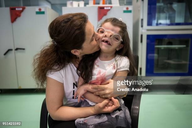 Year-old Elif Ada, who was born with a visual impairment due to a genetic disease poses for a photo with her newly produced eyeglass using 3D...